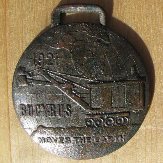 An-Old-And-Dated-Watch-Fob-In-The-Woods